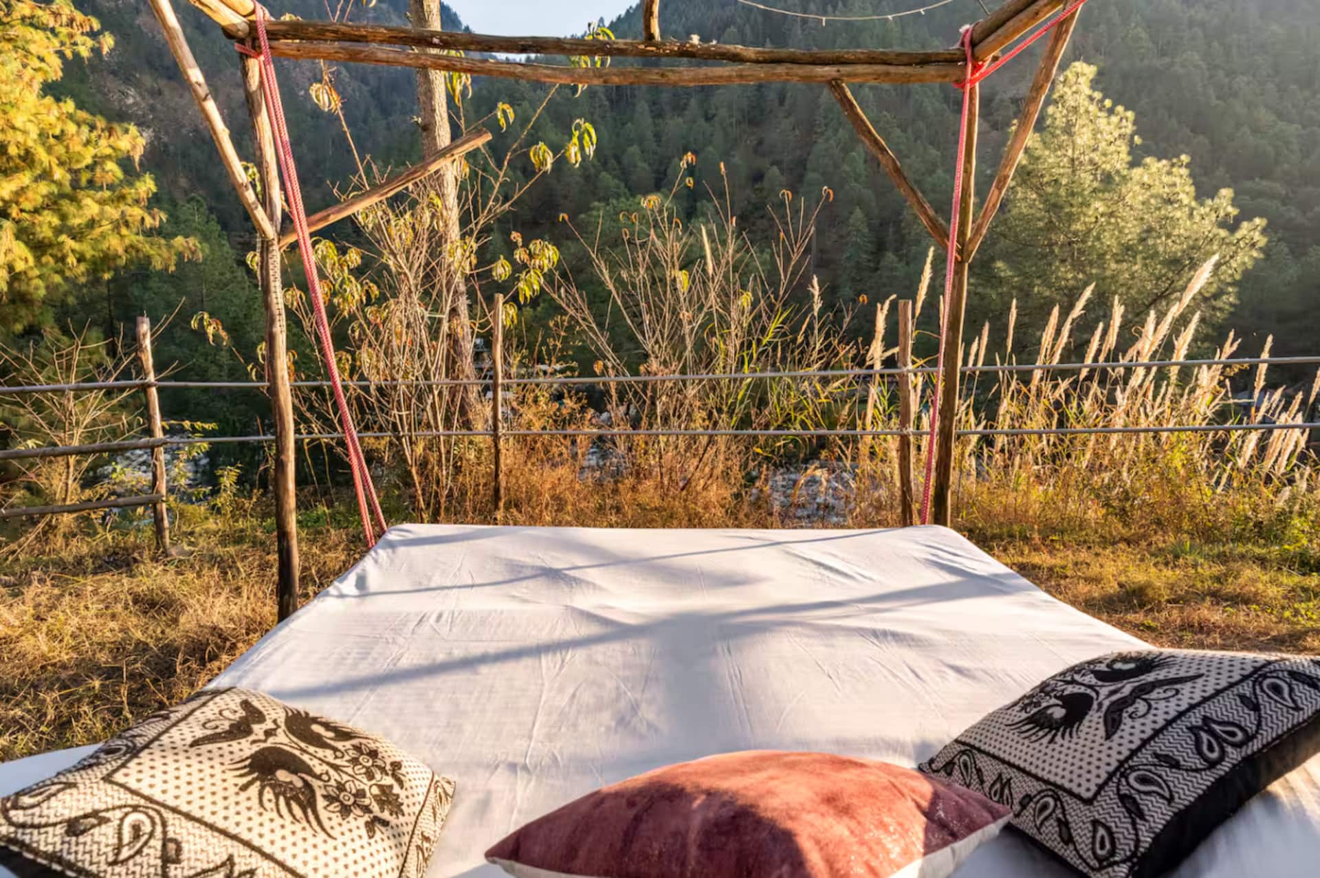 A wooden daybed above the river